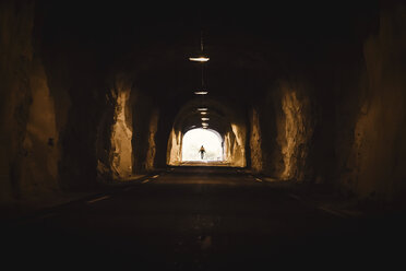 Norway, Lofoten Islands, Maervoll, silhouette of man at the end of a tunnel - WVF00966