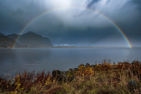 Norway, Lofoten Islands, Bostad, rainbow and dark clouds stock photo