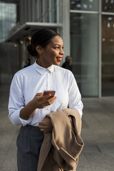Portrait of smiling businesswoman with cell phone - MAUF01372