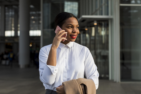 UK, London, portrait of smiling businesswoman on the phone stock photo