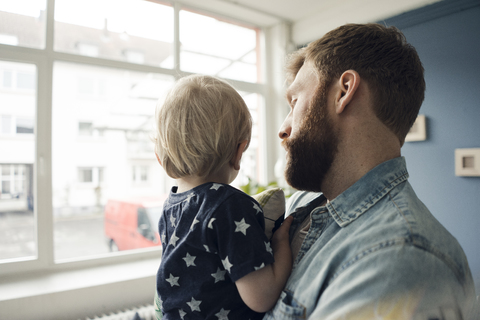 Father spending time with his son at home stock photo