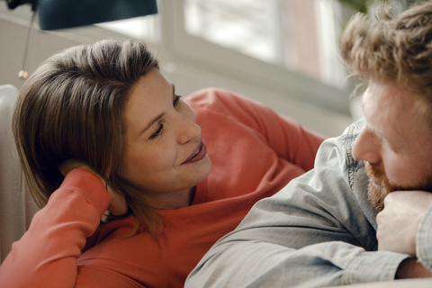 Happy couple at home talking and listening to each other stock photo