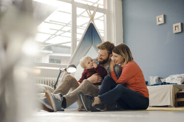 Happy family playing with their son at home - KNSF03746