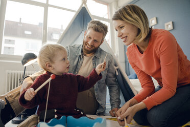 Happy family playing with their son at home - KNSF03751