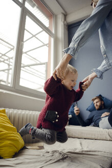 Happy family playing with their son at home - KNSF03760