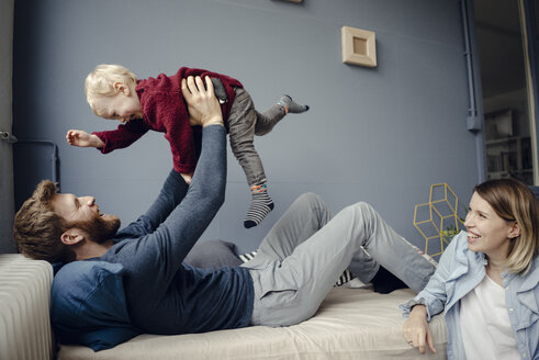 Happy family playing with their son at home - KNSF03762