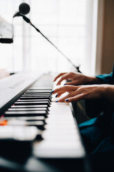 Ausgeschnittenes Bild einer Klavier spielenden Frau am Fenster eines Ateliers - MASF00860