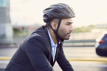 Side view of businessman wearing helmet in city - MASF01060