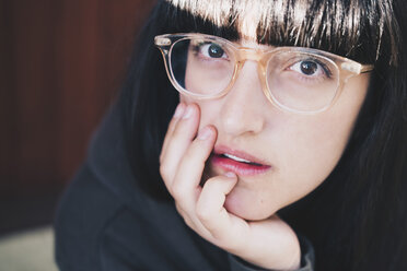 Portrait of woman wearing eyeglasses resting with hand on chin - MASF01309