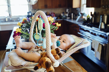 Hohe Winkel Ansicht von Baby-Junge in Baby-Sitz in der Küche zu Hause - CAVF35172