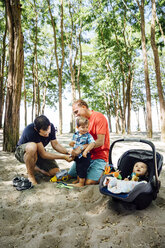 Homosexual couple with children at beach - CAVF35185