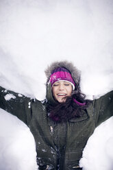 Young woman lying in snow - CAVF35308