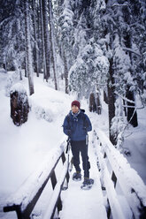 Young hiker on footbridge in winter - CAVF35313