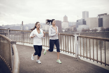 Women running on bridge - CAVF35378