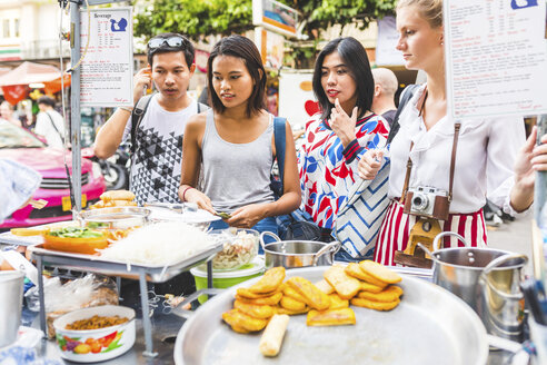 Thailand, Bangkok, Khao San Road, Gruppe von Freunden, die auf dem Straßenmarkt einheimische Lebensmittel auswählen - WPEF00200