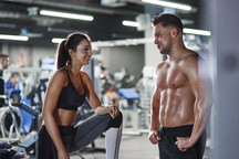 Smiling man and woman talking in gym Stock Photo by ©Syda_Productions  75720277