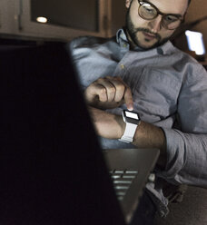 Geschäftsmann im Büro mit Smartwatch - UUF13253