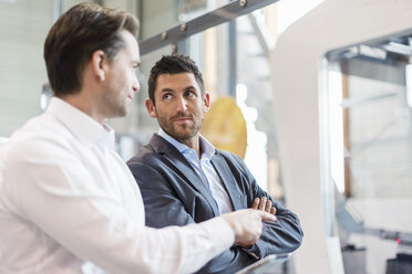 Two businessmen with tablet talking in modern factory - DIGF03693