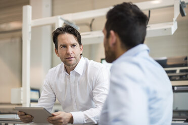 Two businessmen with tablet talking in modern factory - DIGF03702