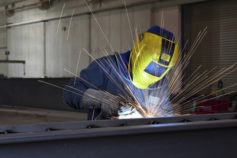 Welder at work in factory stock photo