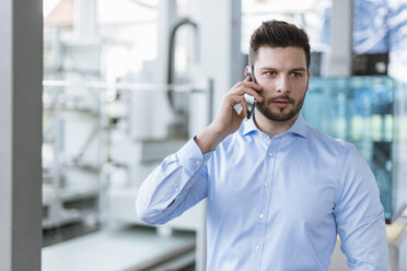 Portrait of man on cell phone in factory - DIGF03791