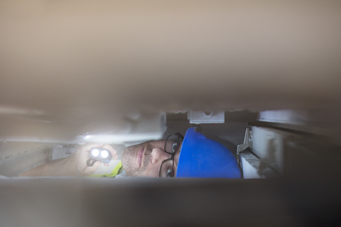 Electrician giving light with flashlight stock photo