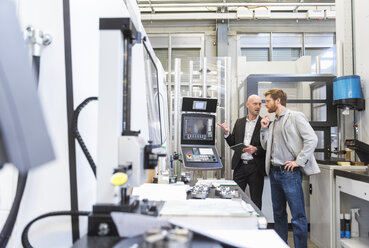 Two businessmen with tablet talking in modern factory - DIGF03812