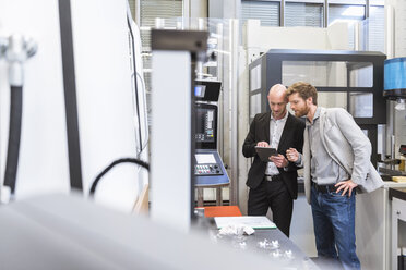 Two businessmen with tablet talking in modern factory - DIGF03813