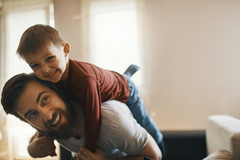 Portrait of happy father and little son playing together at home - ZEDF01290