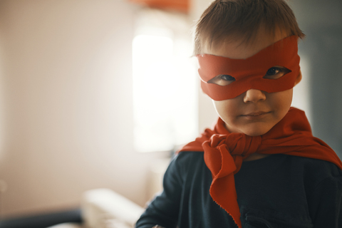 Portrait of funny little boy dressed up as a superhero stock photo