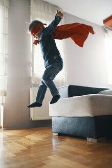 Little boy dressed up as a superhero playing at home - ZEDF01320