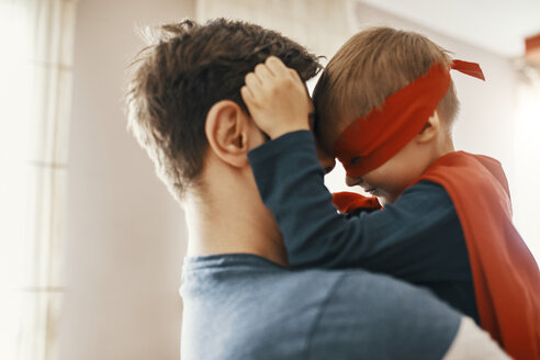 Little boy dressed up as a superhero on his father's arms - ZEDF01323