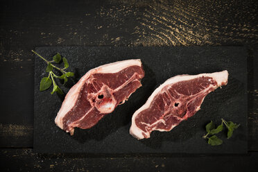 Raw meat, lamb chops on slate - MAEF12565