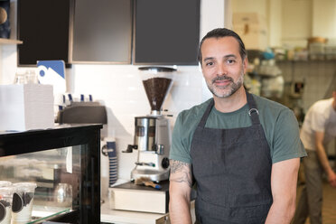 Portrait of confident mature male owner standing at bakery - MASF01407