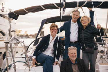 Portrait of smiling male and female senior friends in yacht during vacation - MASF01438