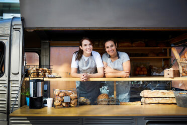 Portrait of smiling female owners in food truck parked in city - MASF01449