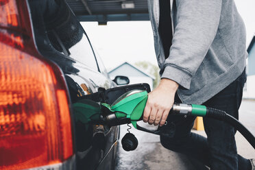 Midsection of man refueling car at gas station - MASF01578