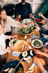 High angle view of happy friends enjoying food in cottage - MASF01742