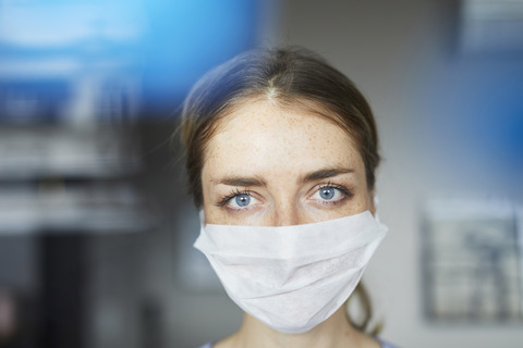 Porträt einer Frau mit chirurgischer Maske, lizenzfreies Stockfoto