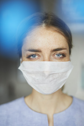 Portrait of woman wearing surgical mask stock photo