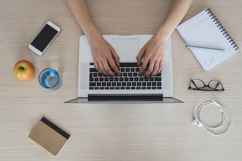 Top view of woman using laptop on table stock photo