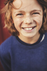 Portrait of cheerful teenage boy in back yard - MASF02197