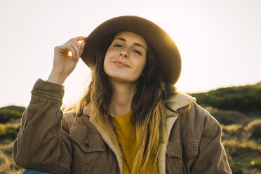 Italy, Sardinia, portrait of smiling woman on a hiking trip - KKAF00953