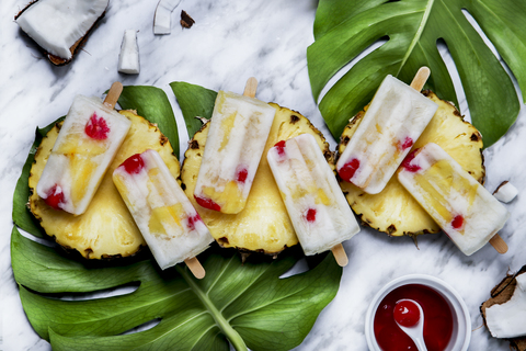 Pina Colada-Eis am Stiel mit kandierten Kirschen und Ananas, lizenzfreies Stockfoto