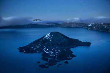 Scenic view of Wizard island in crater lake against sky at dusk - CAVF35605