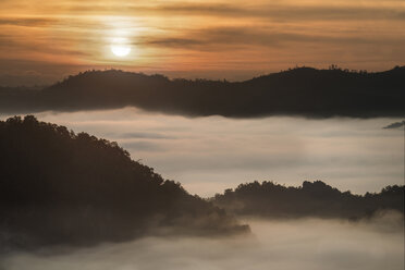 Scenic view of clouds covering mountain during sunset - CAVF35616