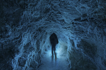 Person standing in illuminated cave at Icefields Parkway - CAVF35759