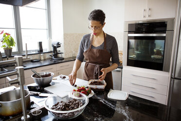 Woman making chocolate truffle at home - CAVF35815