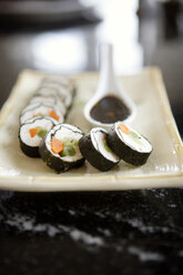 Close-up of sushi rolls in tray on kitchen counter - CAVF35829