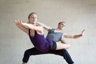 Ballet dancers practicing against wall in studio - CAVF35879